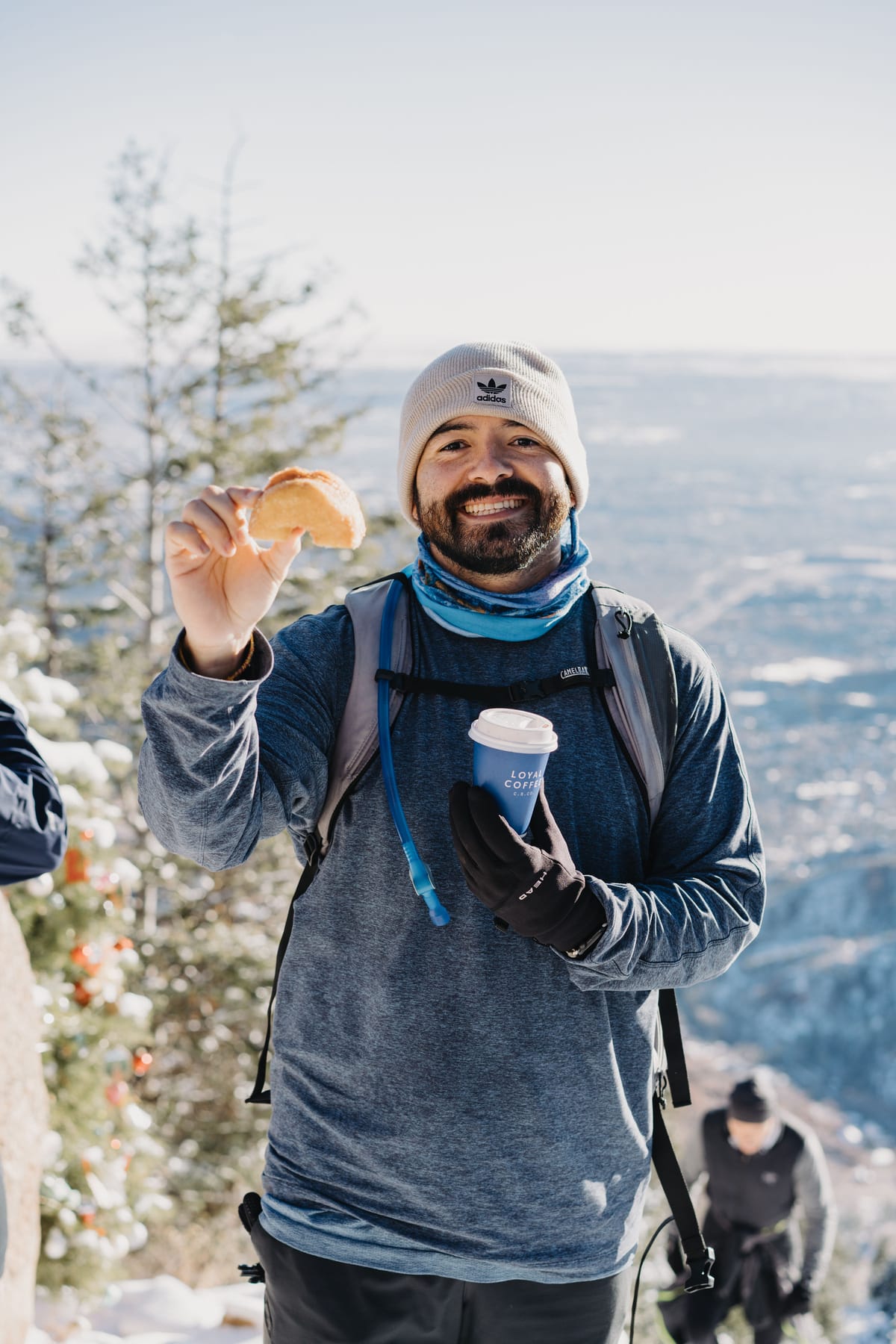 Volunteer holding coffee at the summit